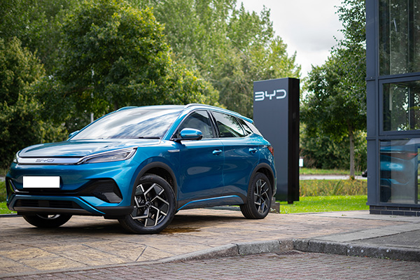 BYD ATTO 3 in Surfing Blue in front of BYD sign outside BYD Exeter showroom