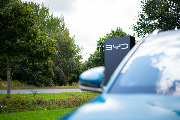 BYD sign in the distance with blue atto 3 car in front