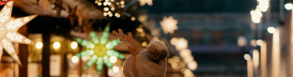 Hat and Antlers head band with Christmas lights and stalls in background