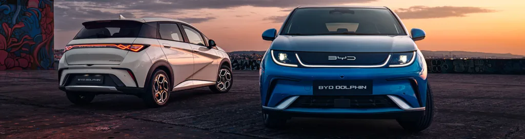 Two BYD Dolphin models against a sunset